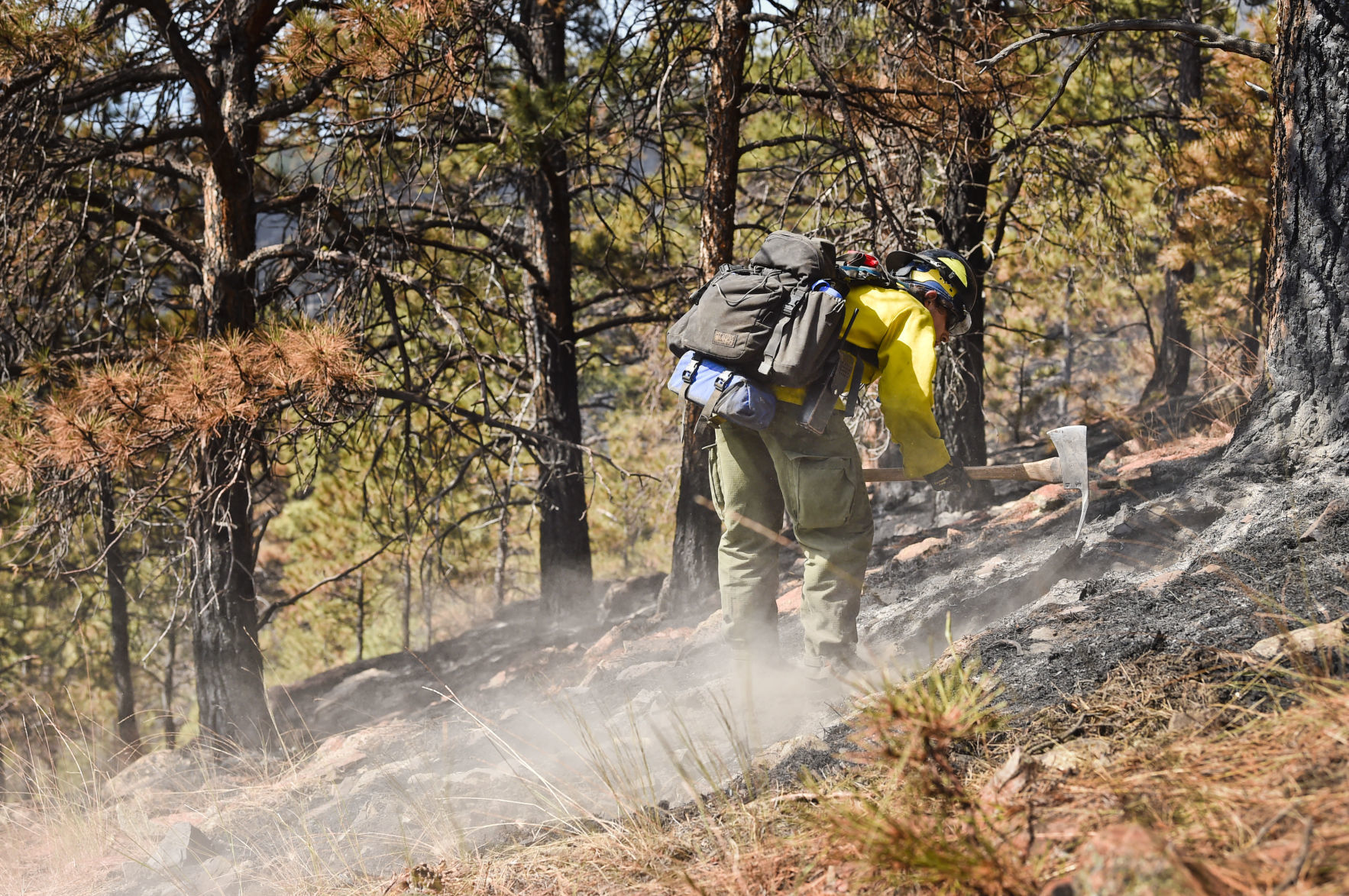 A wildland firefighter works the North Hills Fire
